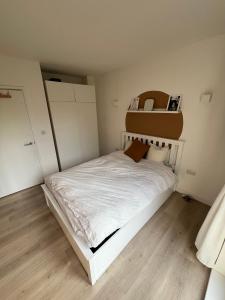 a small bedroom with a white bed in it at The Nest Tottenham - cosy one bed apartment in London