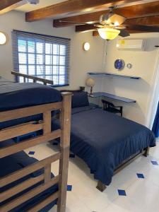 a bedroom with two beds and a desk at Hostal Paraiso Minca in Minca