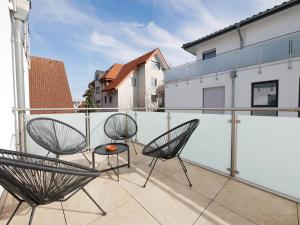 a balcony with two chairs and a table on it at 85qm, Parkplatz, zentral, großer Balkon, 2 Bäder in Paderborn