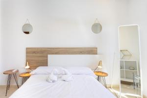 Un dormitorio con una cama blanca con dos toallas blancas. en EDEN RENTALS Malvasia Hideaway, en El Médano