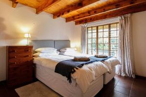 a bedroom with a large bed and a window at 19 Mount Champagne in Winterton +9 photos