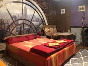 a large bed in a room with a large window at Guest House Niya in Beli Iskar