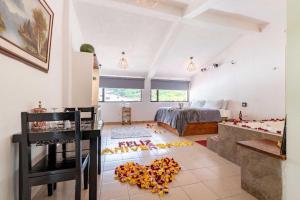 a living room with a bed and a room with a lot of petals on at Hosteria Pampallacta in Papallacta