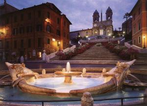 Una fuente en medio de una ciudad con un edificio. en Domus Merulana Bed and Breakfast, en Roma
