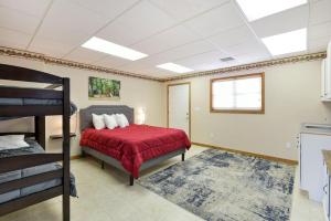 a bedroom with a bed with a red bedspread at 5 Bedroom Vacation Home Next To Silver Dollar City in Branson