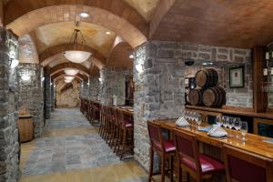 a restaurant with stone walls and wooden tables and chairs at Rio Hotel & Casino in Las Vegas