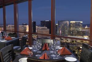 a restaurant with a view of a city at night at Rio Hotel & Casino in Las Vegas