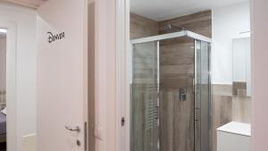 a shower with a glass door in a bathroom at Wanderlust Guesthouse in Gaeta