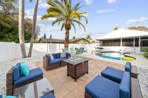 a patio with chairs and a table and a pool at Lux Sunny Family Paradise with Heated Pool and King Bed in Largo