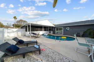 a backyard with a pool and a house at Lux Sunny Family Paradise with Heated Pool and King Bed in Largo