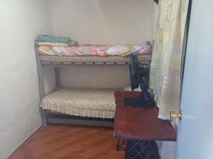 アグアス・ドゥルセスにあるAmanecer en aguas dulcesの二段ベッド2台とテーブルが備わる客室です。