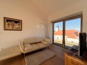 a living room with a couch and a large window at Villa Boris in Starše