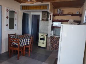 una piccola cucina con tavolo e frigorifero di Amanecer en aguas dulces ad Aguas Dulces