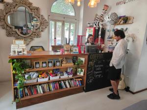 a woman standing at the counter of a coffee shop at Metro Hostal Boutique in Mexico City