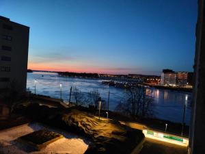 a view of a river at night from a building at Seaview apartment central location Helsinki in Helsinki