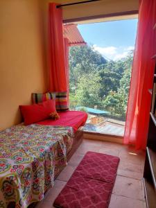 a bedroom with a bed and a large window at Villa Stellia @drvacationsrental in La Laguna