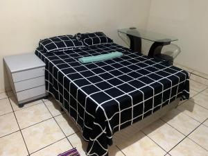 a black and white bed with a table on it at 203 verão kit exclusiva in Brasilia