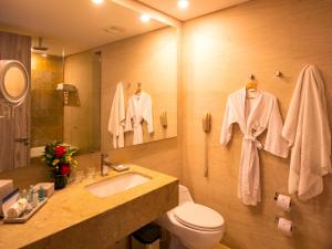 a bathroom with a sink and a toilet and a mirror at Las Americas Torre Del Mar in Cartagena de Indias