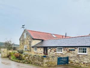 an old stone house with a red roof at Twattleton Cottage Kilburn Yorkshire - Beautiful views in York