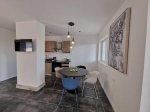 a kitchen and dining room with a table and chairs at App Moonlight, Omišalj, Krk in Omišalj
