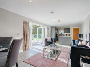 a living room with a couch and a table at 1 Bed in Sandyhills 85904 in Fairgirth