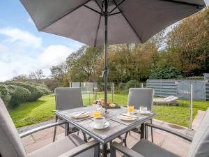 a table with an umbrella on a patio at 1 Bed in Sandyhills 85904 in Fairgirth
