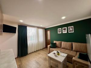 a living room with a couch and a table at Byurakan Villas near Kari Lake in Byurakan