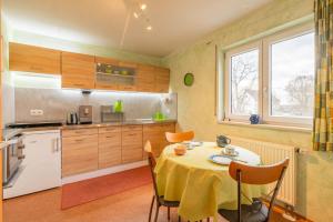 a kitchen with a table with a yellow table cloth at Ruhe auf dem Land 1 - Maria in Aulendorf