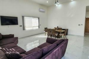 a living room with a couch and a dining table at Villa Costa Felix 5 in Puerto Peñasco