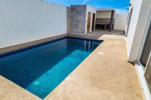 a swimming pool with blue water in a house at Villa Costa Felix 5 in Puerto Peñasco