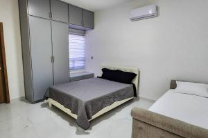 a bedroom with a bed and a cabinet and a couch at Villa Costa Felix 5 in Puerto Peñasco +43 photos