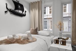 Dormitorio blanco con cama con manta peluda en Renovated 03.24 - Viking inspired - Behind bryggen, en Bergen