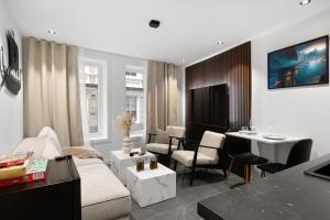 a living room with a couch and a table at Renovated 2024 - Viking inspired - Behind bryggen in Bergen