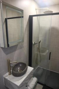 a bathroom with a sink and a shower at LakEscape - Waterfront Self- Catering Cabins in Enniskillen