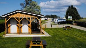 a gazebo in a park with a parking lot at Binka - Luxury 40 x 14ft Lodge in Tain