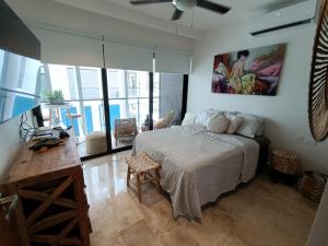 a bedroom with a bed and a table and some windows at Suites calle 38 in Playa del Carmen +162 photos