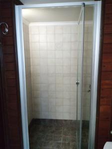 a shower with a glass door in a bathroom at Marathos Bay in Kokkala