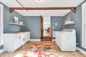 a laundry room with white appliances and a blue wall at Deck & Modern Amenities! Hollyhock Hideaway in South Bend