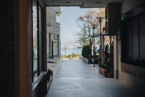 an empty street in an alley with buildings at Sun&Moon Ohridlake Apartments in Pogradec