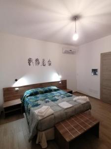 - une chambre avec un grand lit dans l'établissement CLASS ROOMS AFFITTACAMERE, à SantʼAnna Arresi