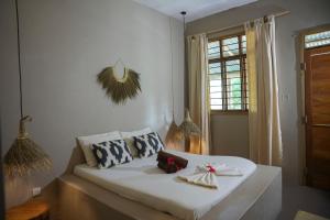 a white couch in a room with a window at Kendwa Breeze Bungalows in Kendwa
