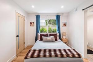 Un dormitorio con una cama grande y una ventana en Luxurious Townhome W/3 Master Suites gated Parking, en Los Ángeles