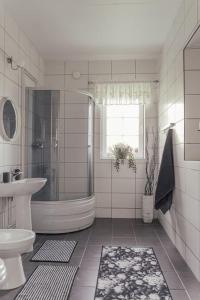 a bathroom with a shower and a toilet and a sink at Målaskog gamla station 1 in Ryssby +44 photos