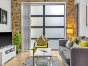 a living room with a couch and a table at Apartment Regents Park Serviced Apartment-2 by Interhome in London