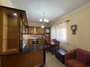 a kitchen with a couch and a table in a room at Tirana Center 2Bedrooms in Tirana