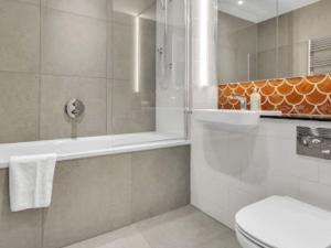 a bathroom with a shower and a toilet and a sink at Apartment Wembley Park apartments-1 by Interhome in London