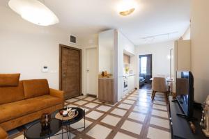 a living room with a couch and a table at Didi's Central Designer Apartments in Sofia