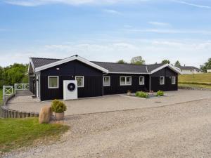 a black modular home with a driveway at Holiday Home Edo - 575m from the sea in Funen by Interhome in Spodsbjerg