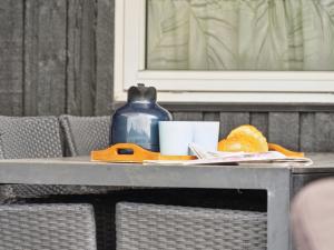 a table with a jug and a plate of food on it at Holiday Home Edo - 575m from the sea in Funen by Interhome in Spodsbjerg