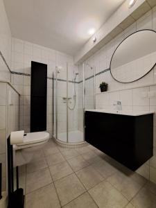 een badkamer met een douche, een toilet en een wastafel bij Wander-Traum-Fewo in Bad Harzburg